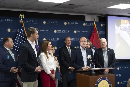 FCC Chairman Brendan Carr (at lectern) with Arkansas Attorney General Tim Griffin (far right), U.S. Sen. Tom Cotton (second from left) and Gov. Sarah Huckabee Sanders.